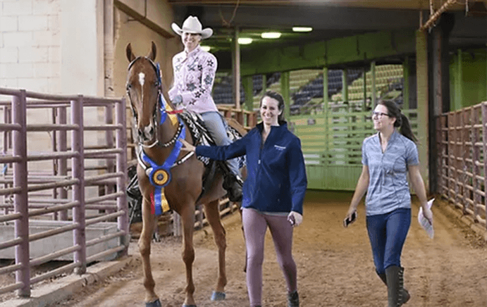 Trainers from Shenanigans Stables leading Student who won out of competition arena.